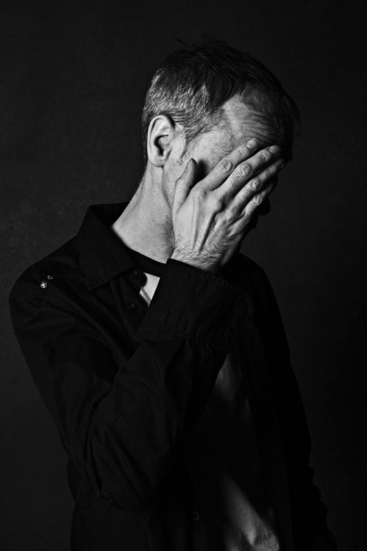 Portret mezczyzna dlonie twarz studio czb — fotografia Maciej Zawiasa